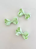 Tiny green overlay bow