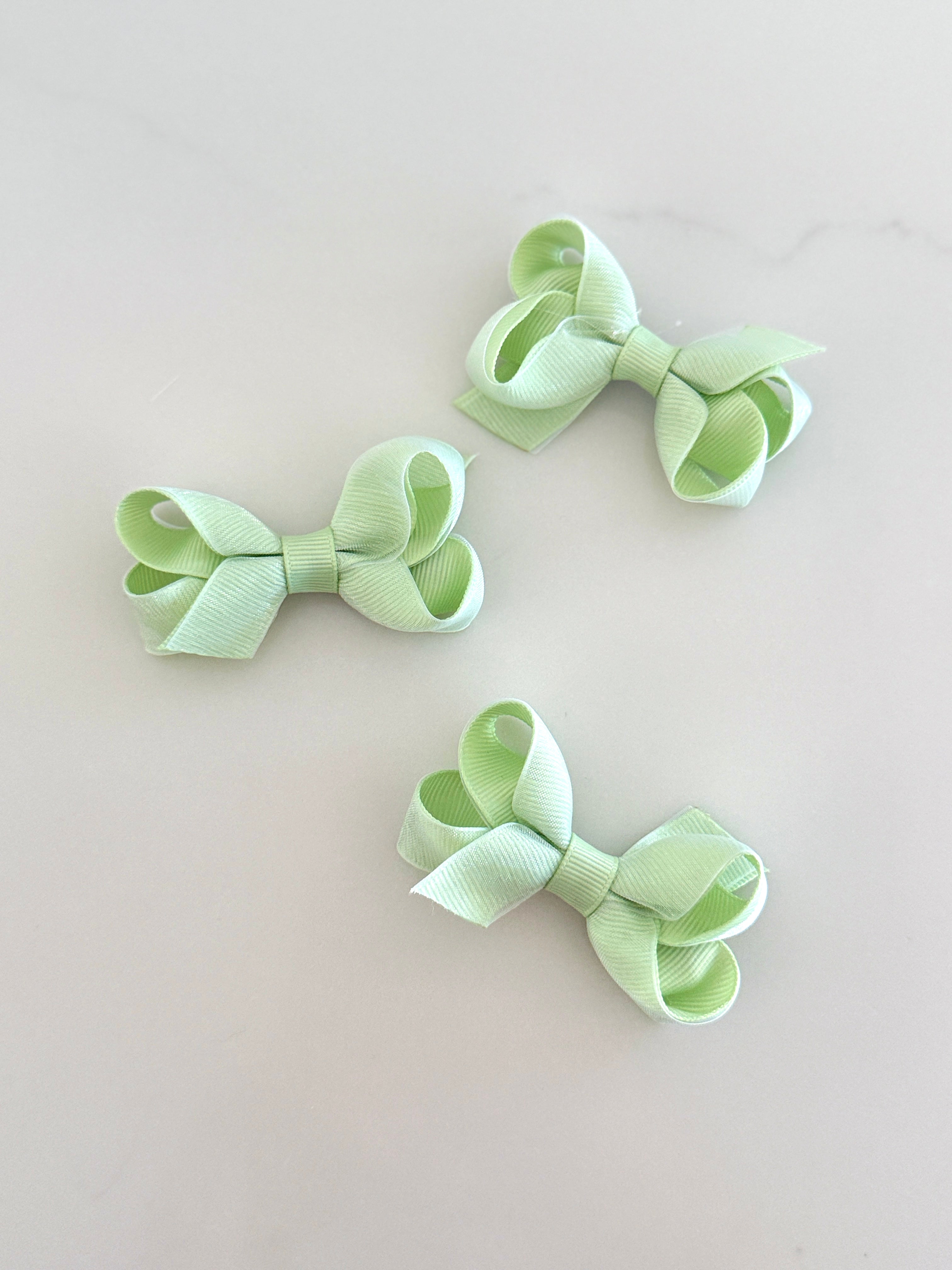 Tiny green overlay bow